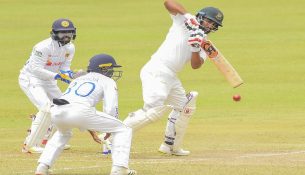 Tamim Iqbal (R) plays a shot-