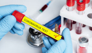 Positive coronavirus blood test concept. Analyzing blood sample in test tube for coronavirus test in doctor hand. Tube with blood for 2019-nCoV or COVID-19 test. Coronavirus blood analysis concept.